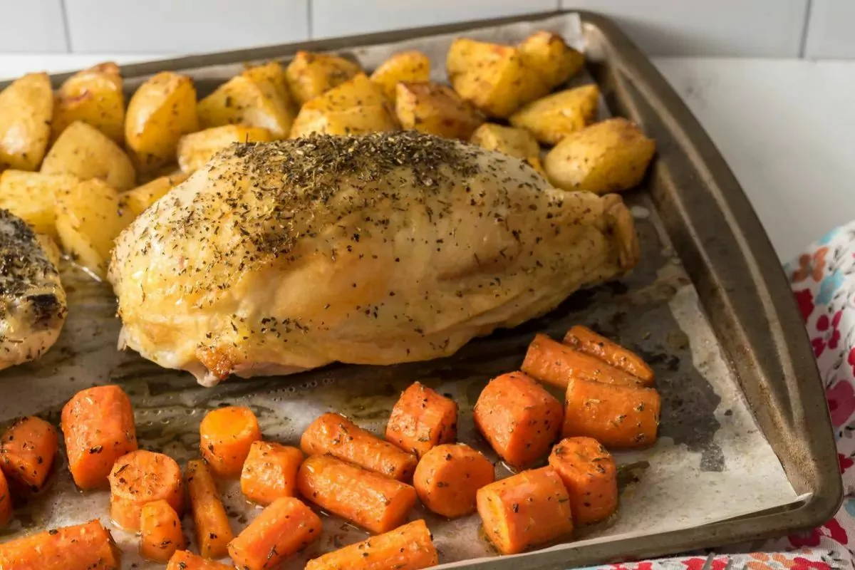 sheet pan with baked chicken carrots and potato