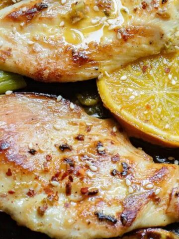 juicy chicken cutlets in a sheet pan with lemon and broccoli