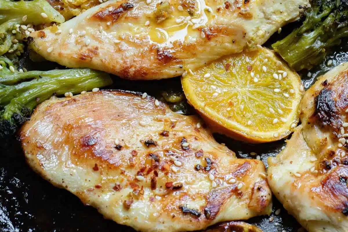 juicy chicken cutlets in a sheet pan with lemon and broccoli