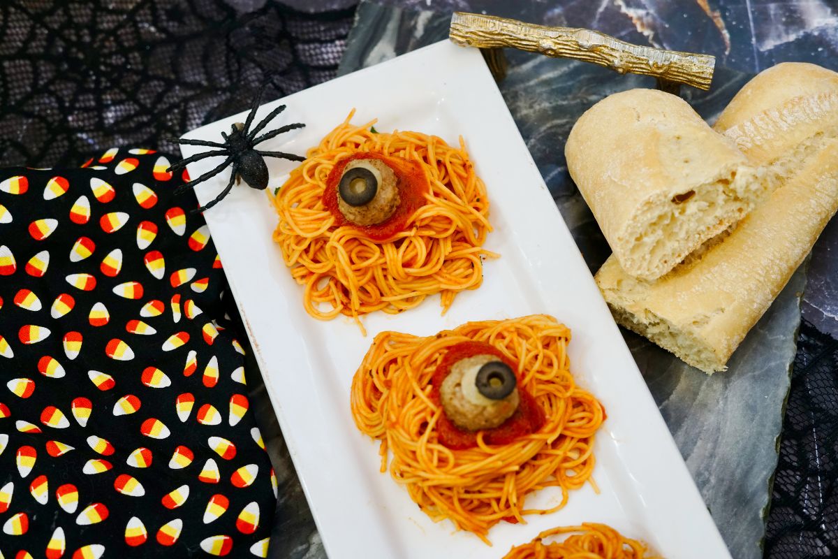 meatballs made to look like eyeballs on top of mounds of spaghetti on plate.