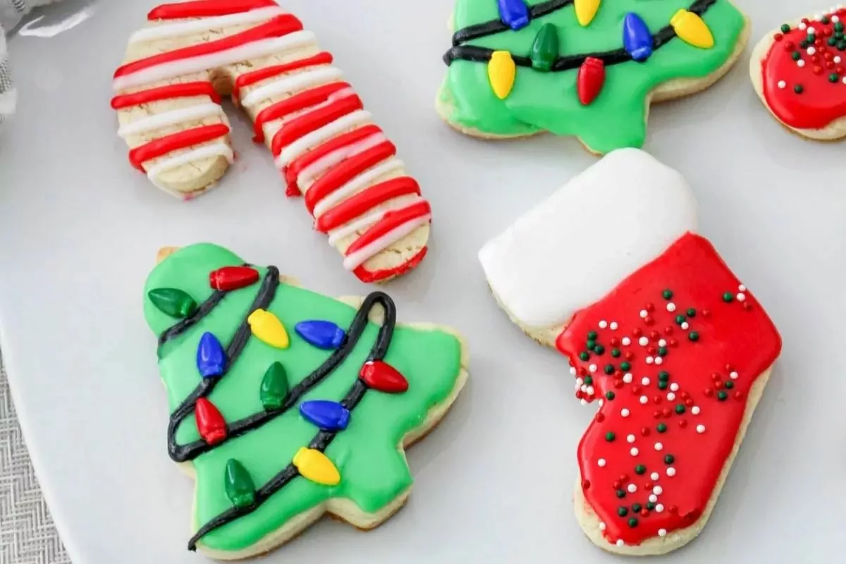 a plate with candy cane sock and christmas tree shape cookies