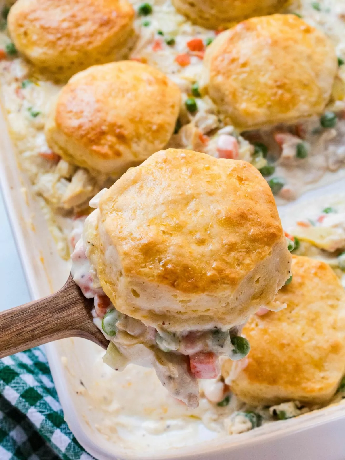 scoop of biscuit chicken pot pie on a wooden spoon