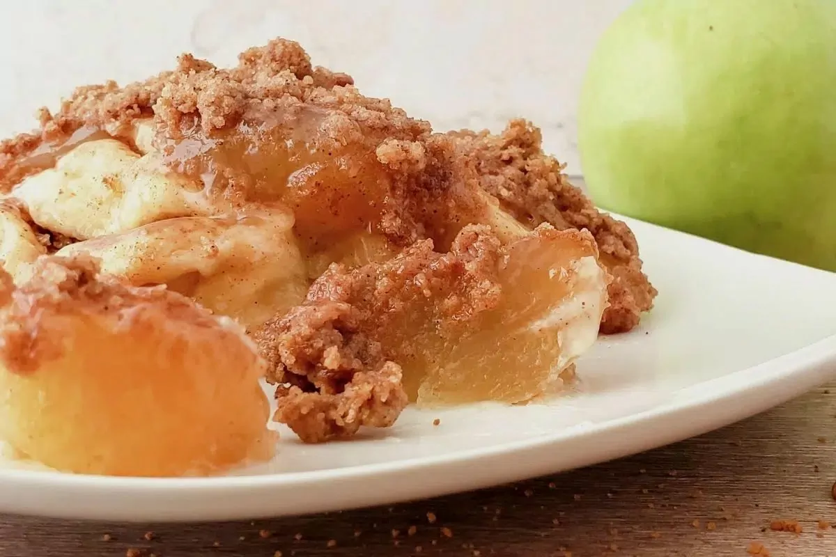 cinnamon rolls apple pie filling on white plate.