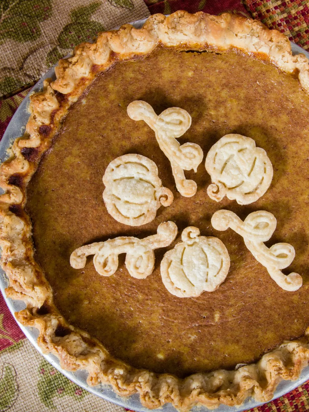 homemade pumpkin with decorative pie dough shapes.