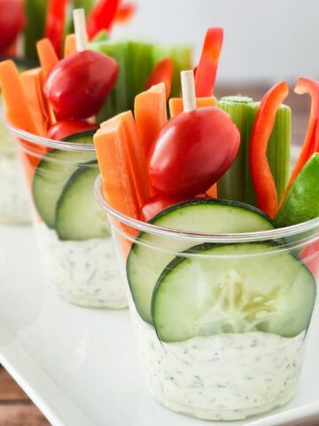 individual cups with dip and veggies.