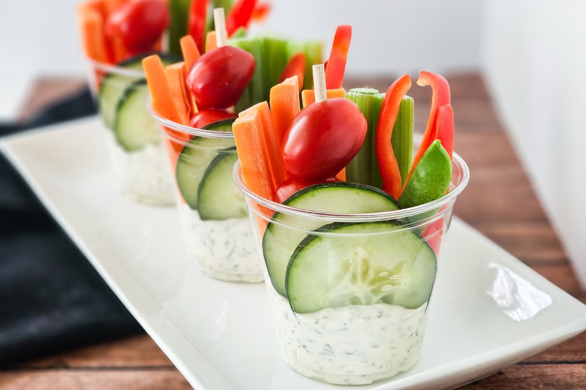 individual cups with dip and veggies.