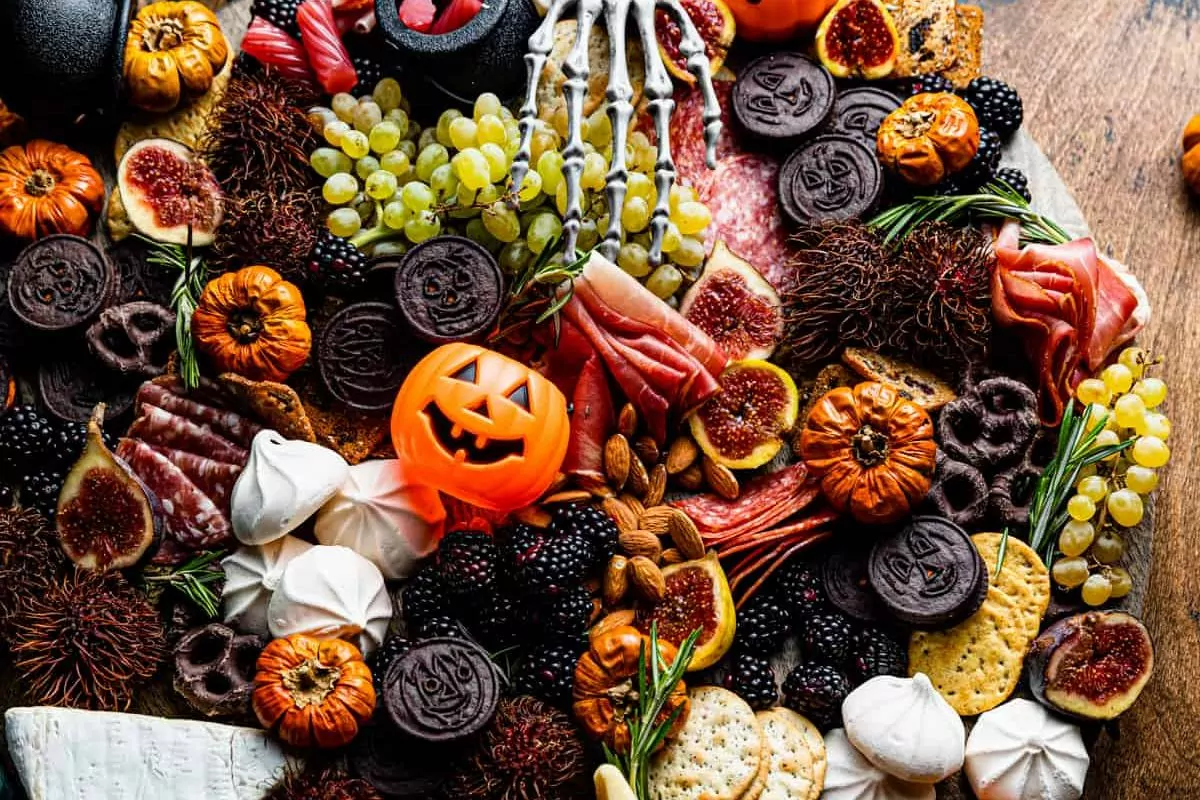 Halloween Charcuterie Board with fruits cookies and chocolate