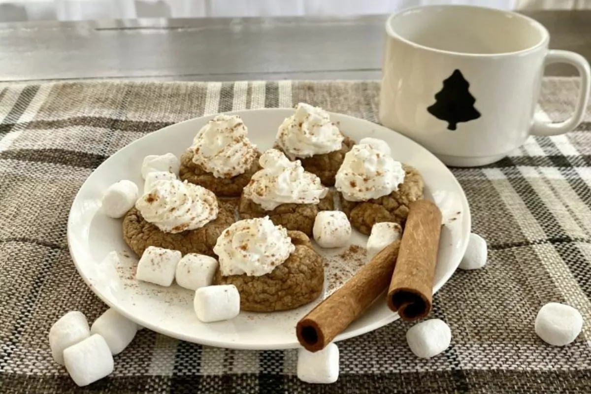 a plate of ginger latte cookies top with whipped cream