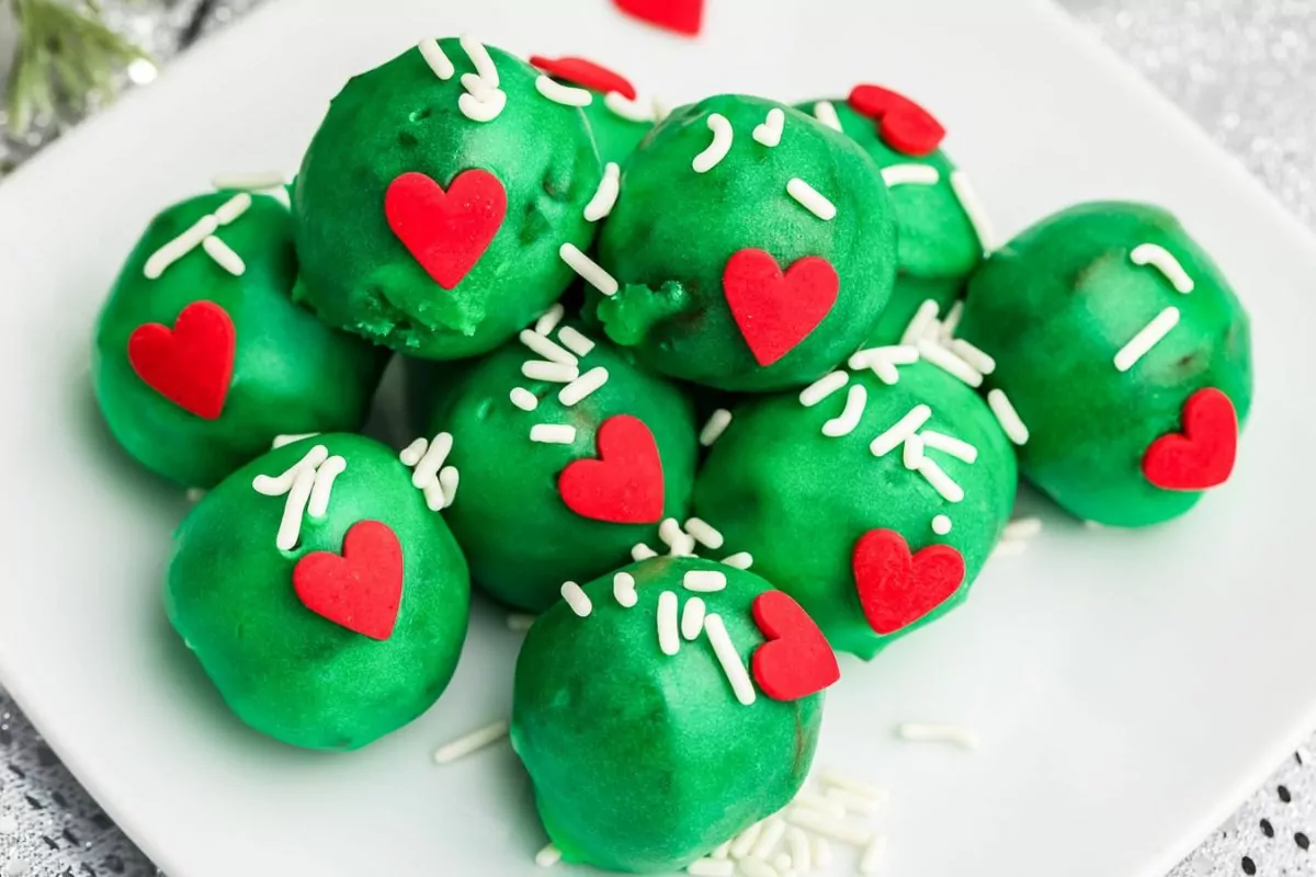 a plate of mini green donuts with sprinkles