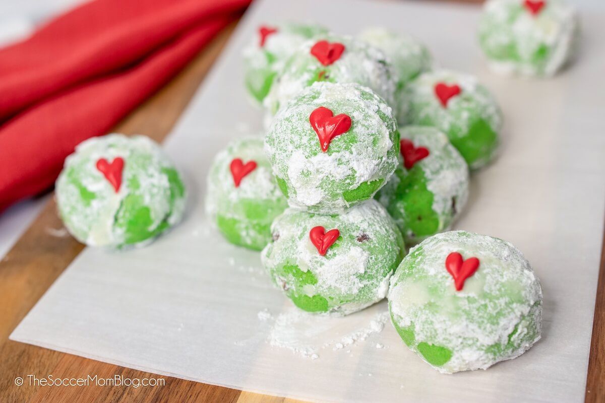 a plate of green colored cookies dust with white sugar