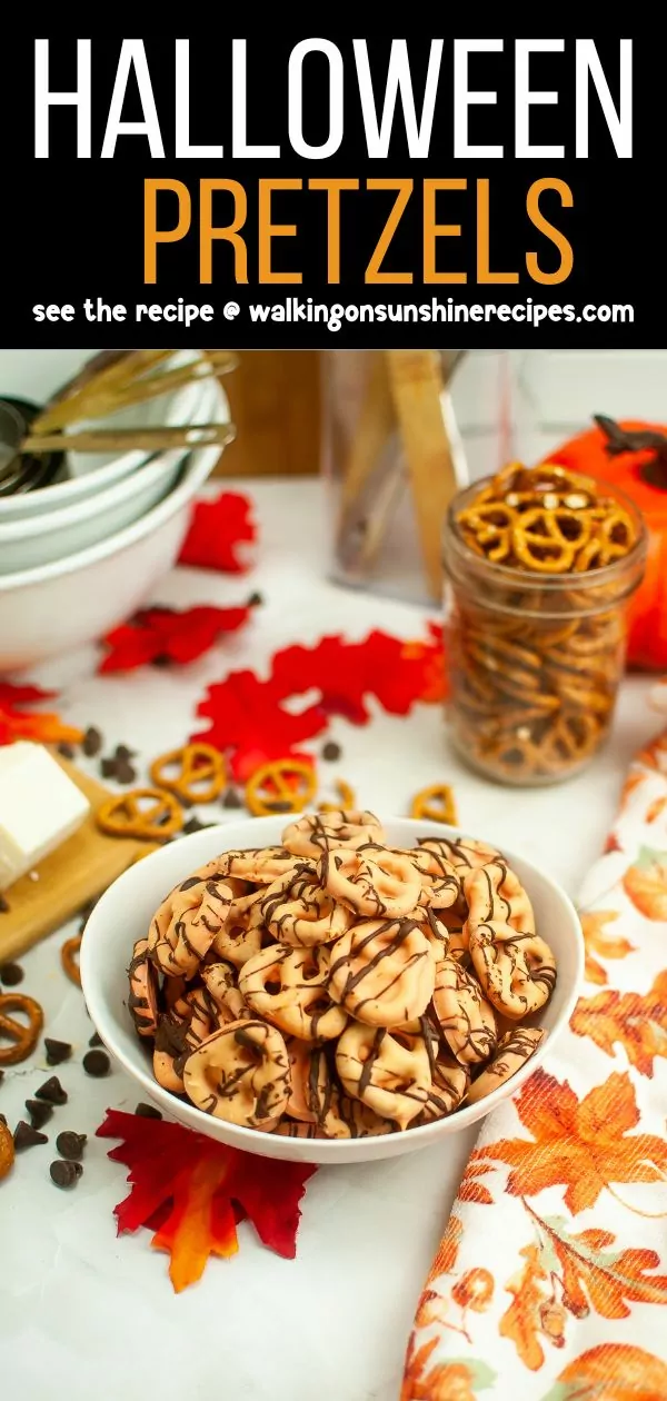 Bowl of pretzel twists dipped in orange colored chocolate.