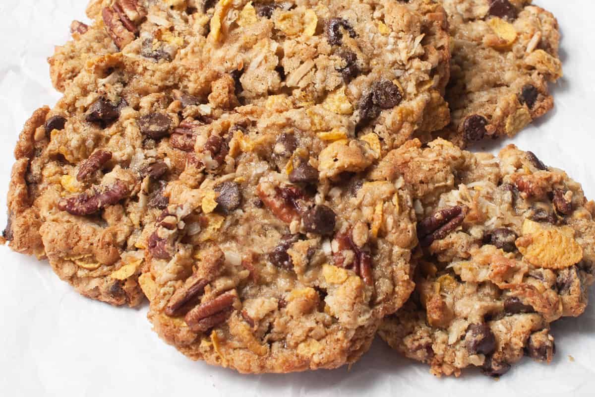 a plate of cookies with chocolate chip and pecan toppings