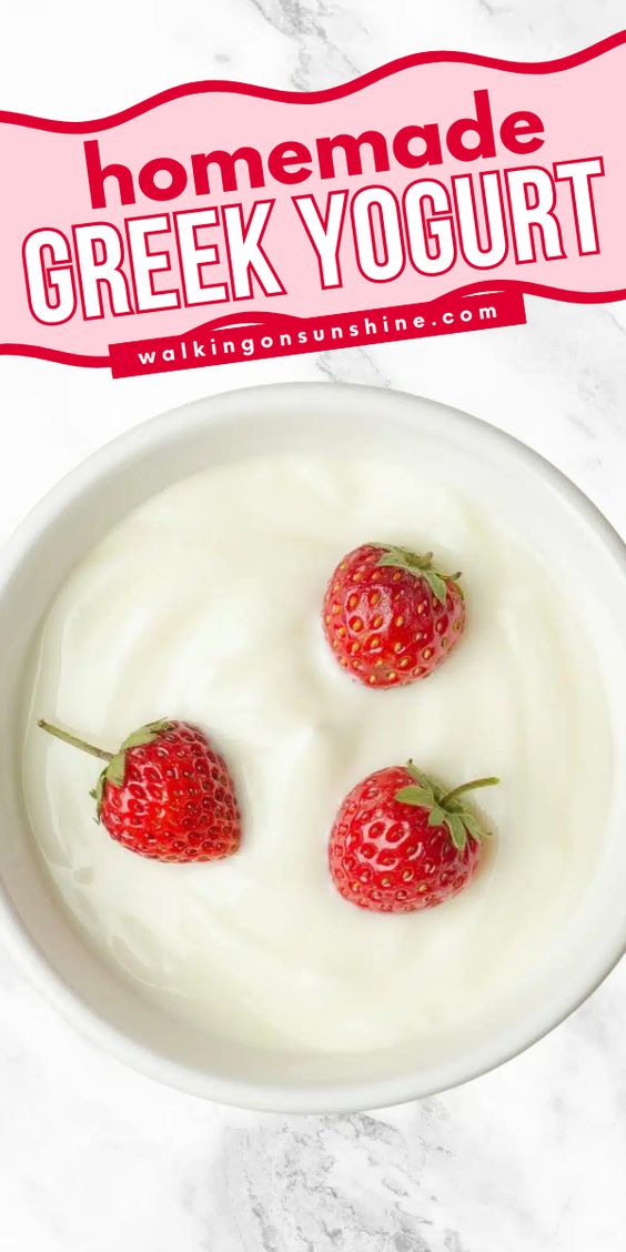 bowl of Greek yogurt with whole strawberries on top.