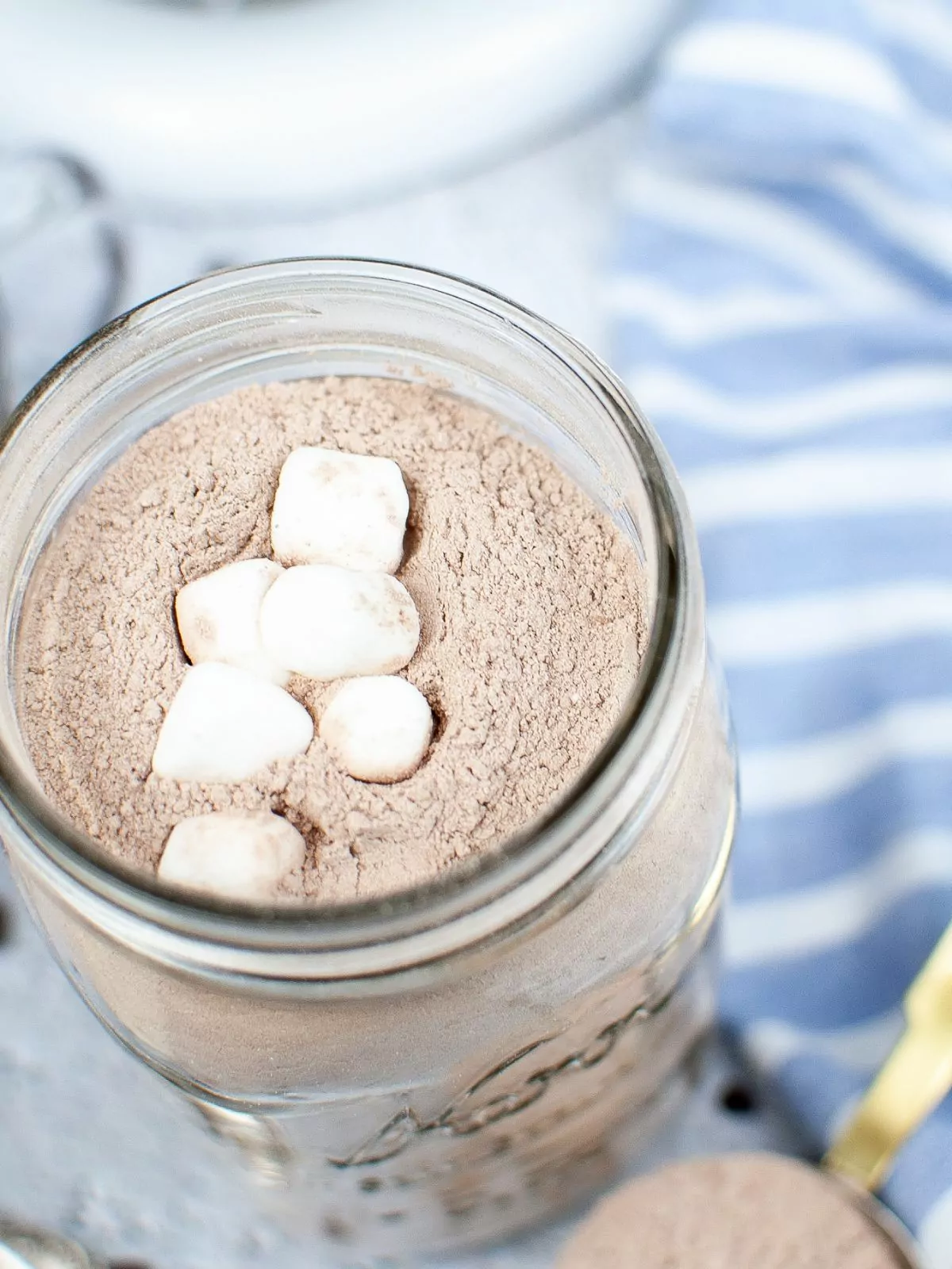 overhead view of hot chocolate mix in mason jar with mini marshmallows.