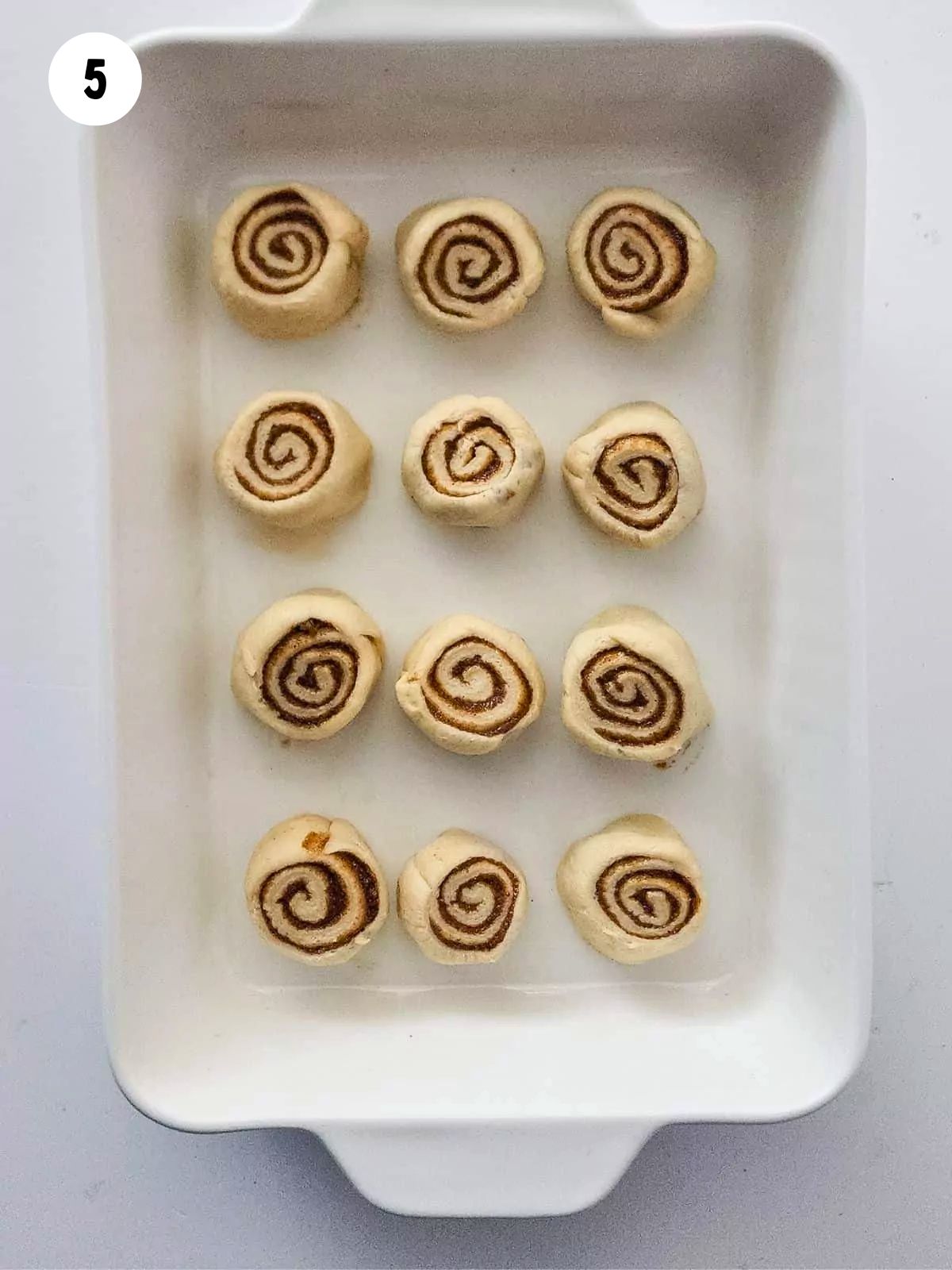 cinnamon rolls before baking in casserole dish.