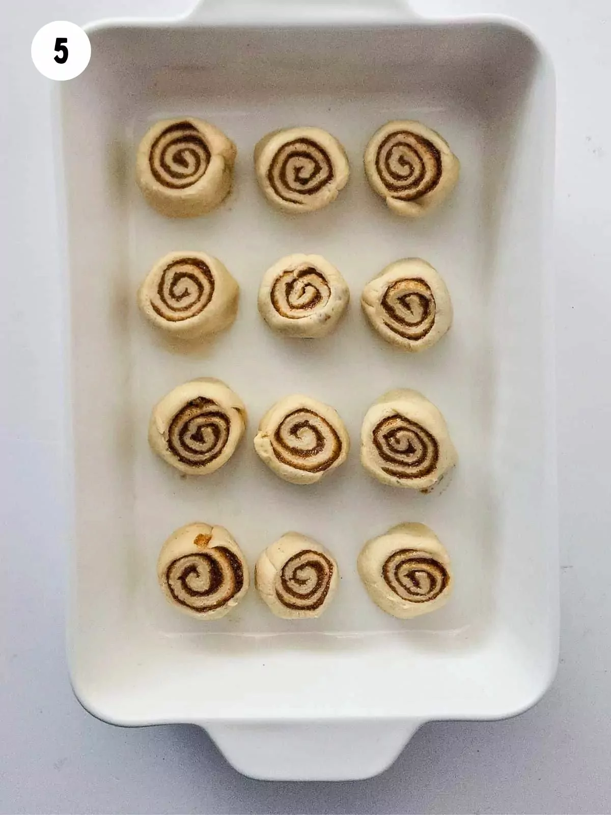 cinnamon rolls before baking in casserole dish.