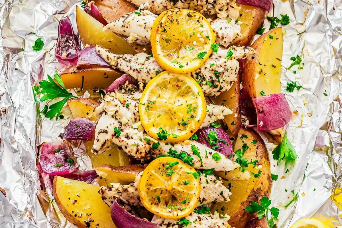 potato chicken with lemon on top and onion foil pack