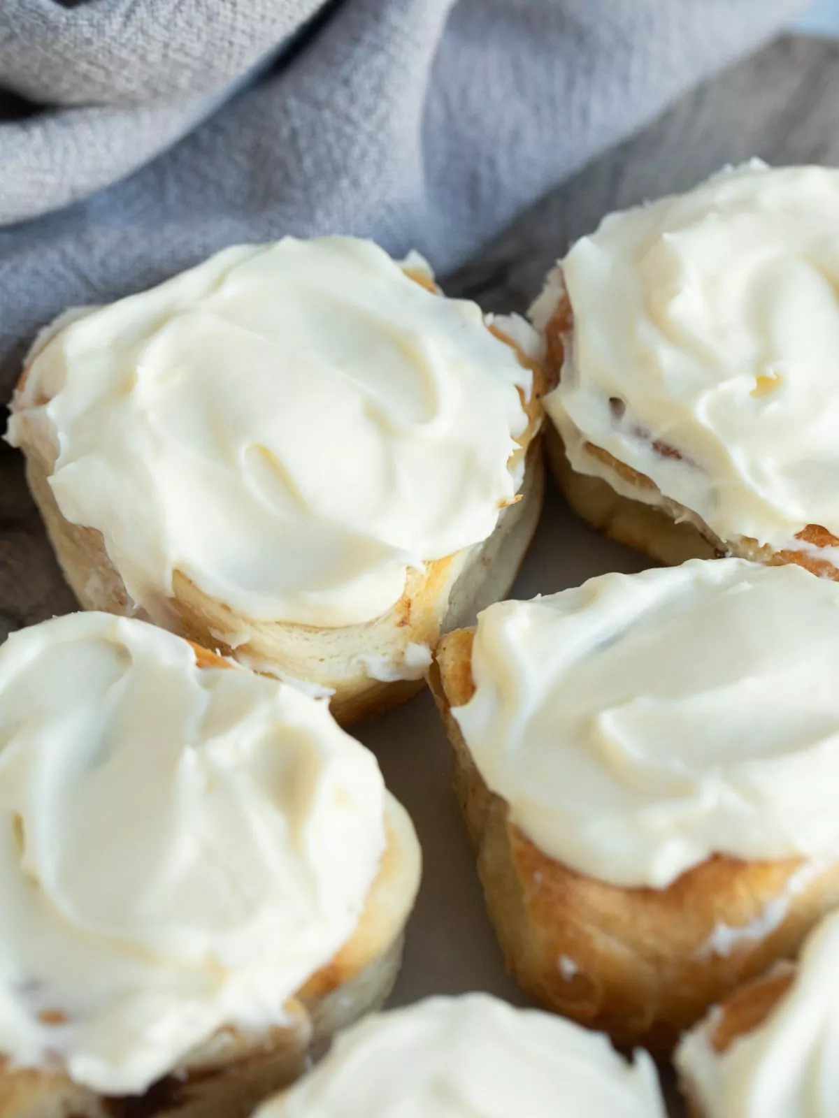 cinnamon rolls frosted on plate.