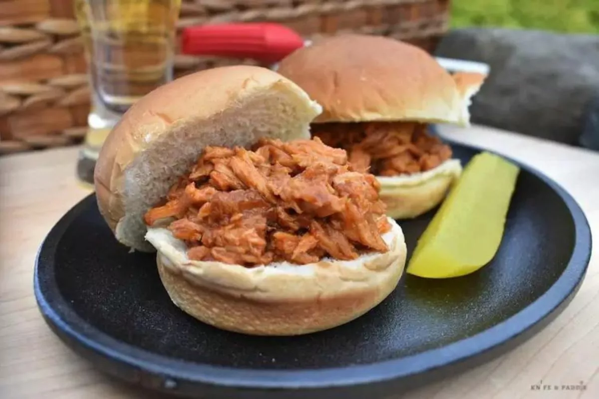 plate of 2 burger buns with pulled pork