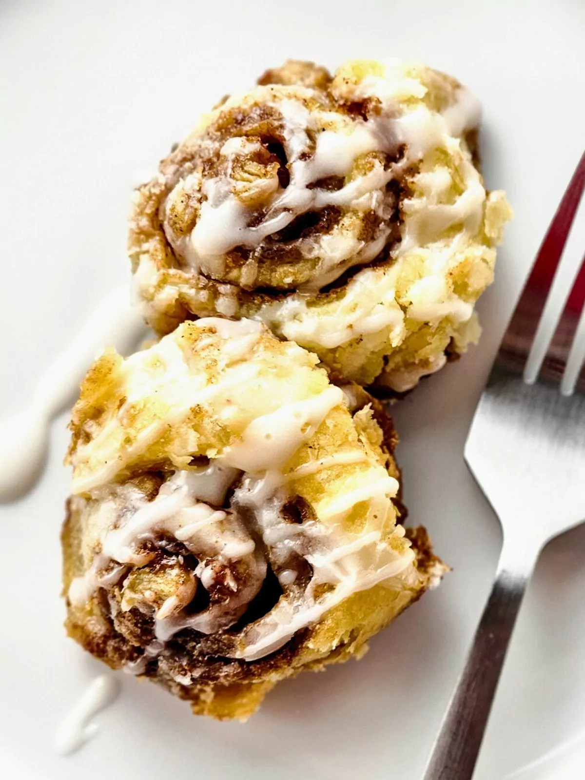 puff pastry cinnamon rolls served on plate with fork.