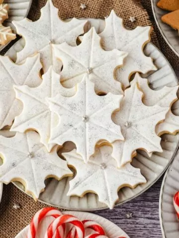 a plate of snowflake cookies