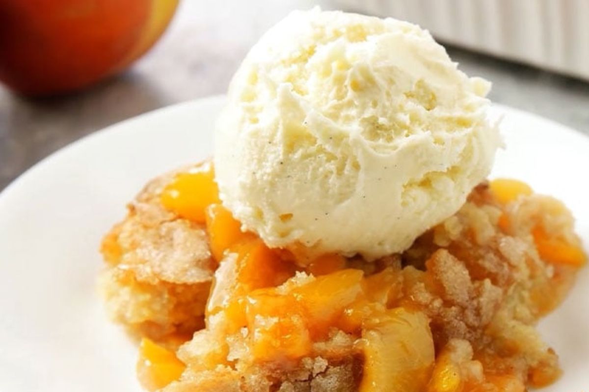 a plate of peach cobbler with ice cream on top