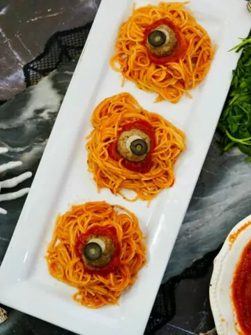 plated served dinner of spaghetti and spooky meatballs.