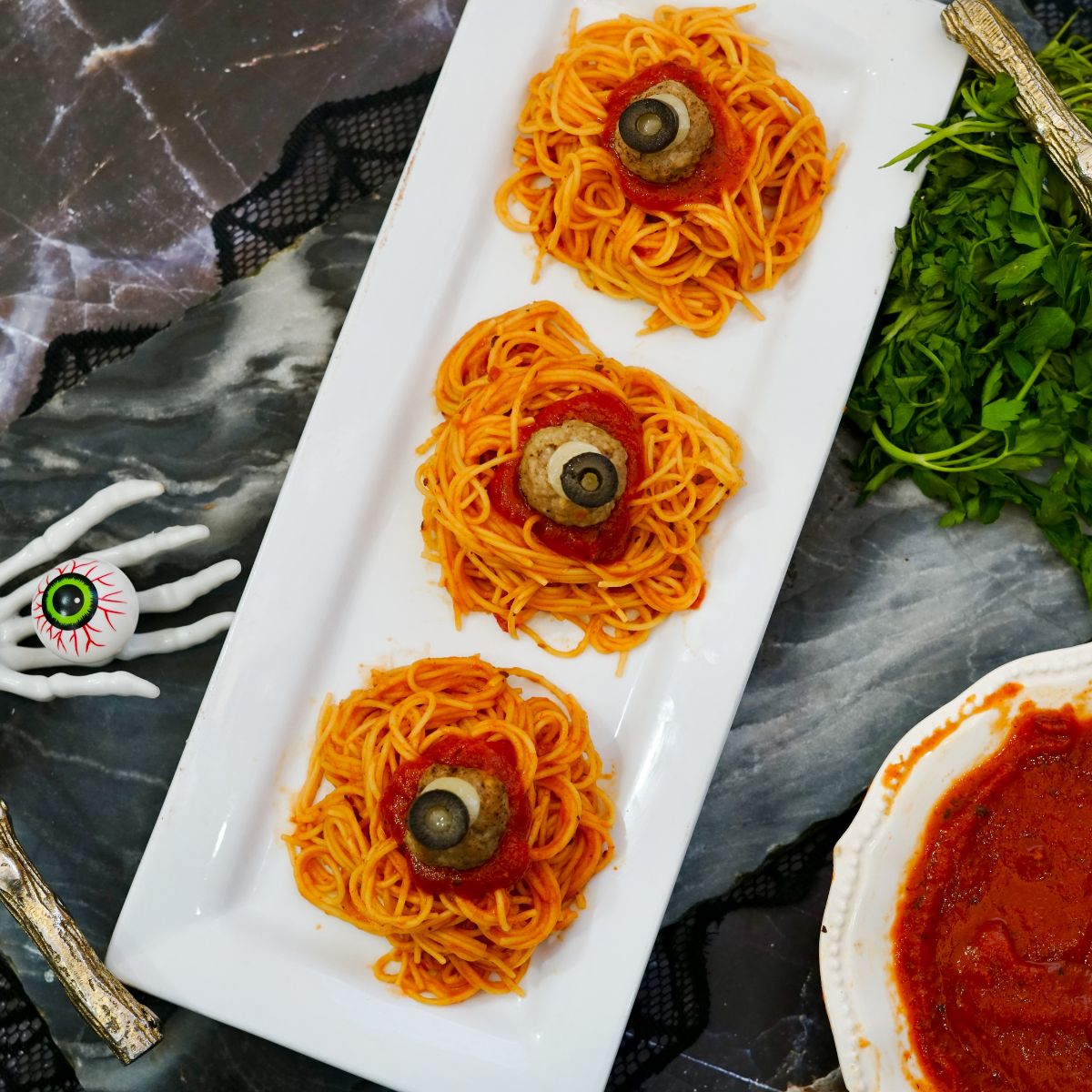 plated served dinner of spaghetti and spooky meatballs.