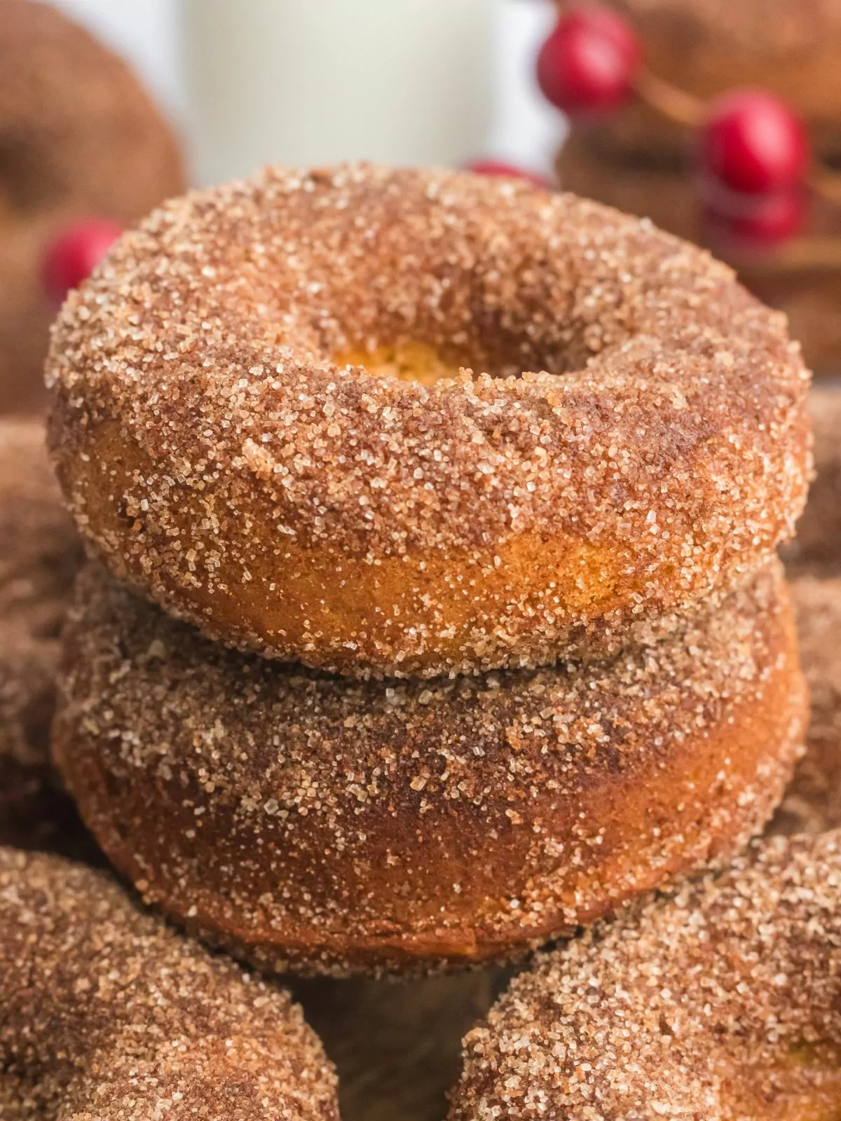 two cinnamon sugar coated pumpkin donuts stacked