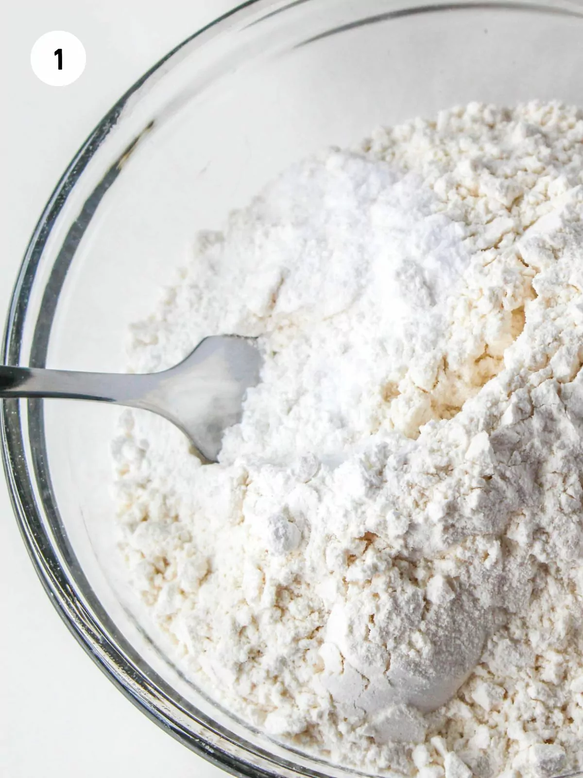 flour, baking soda, baking powder, and salt in a clear mixing bowl