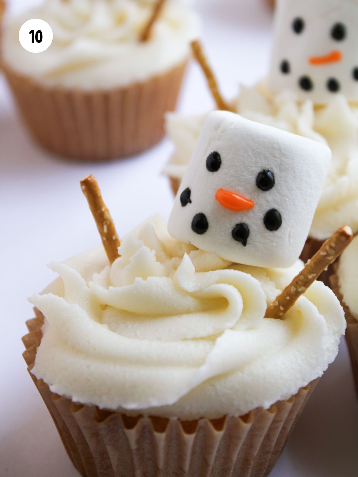 pretzel sticks added to the cupcake for the snowman's arms