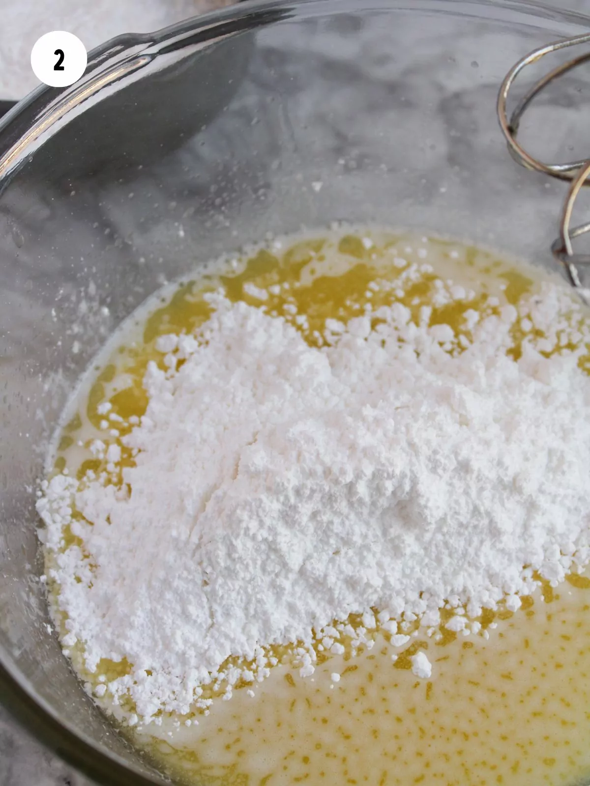 half the powdered sugar added to the bowl of melted butter