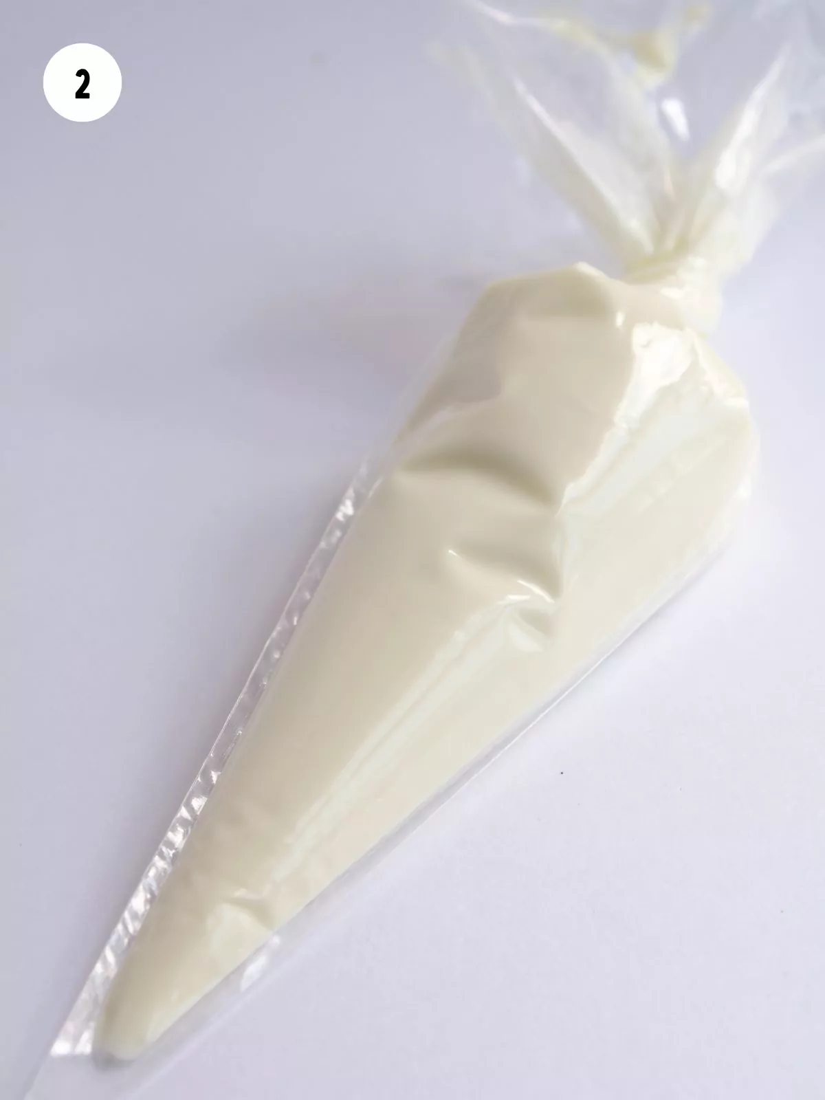 piping bag filled with melted white chocolate