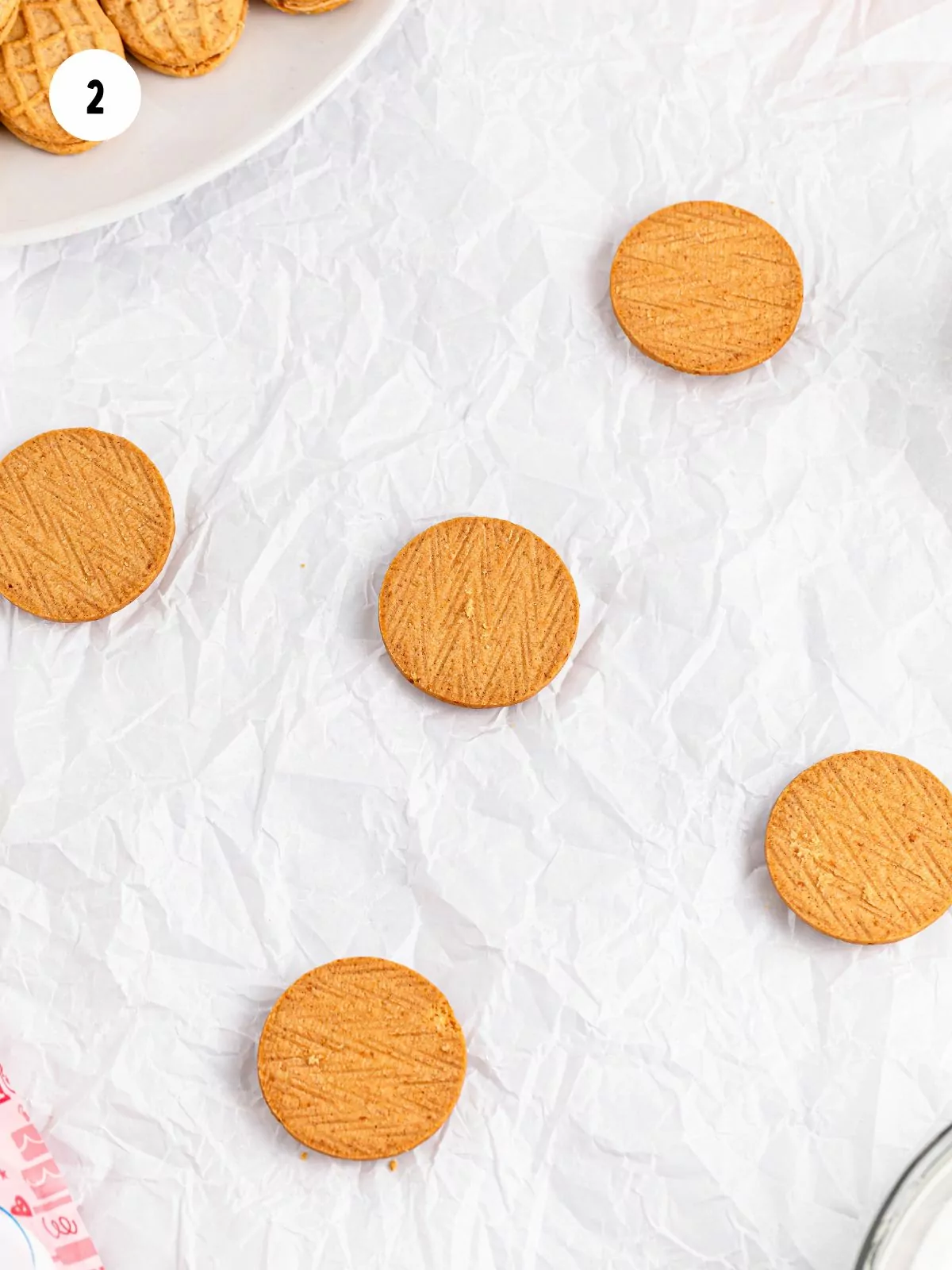 halves of round nutter butters on parchment paper