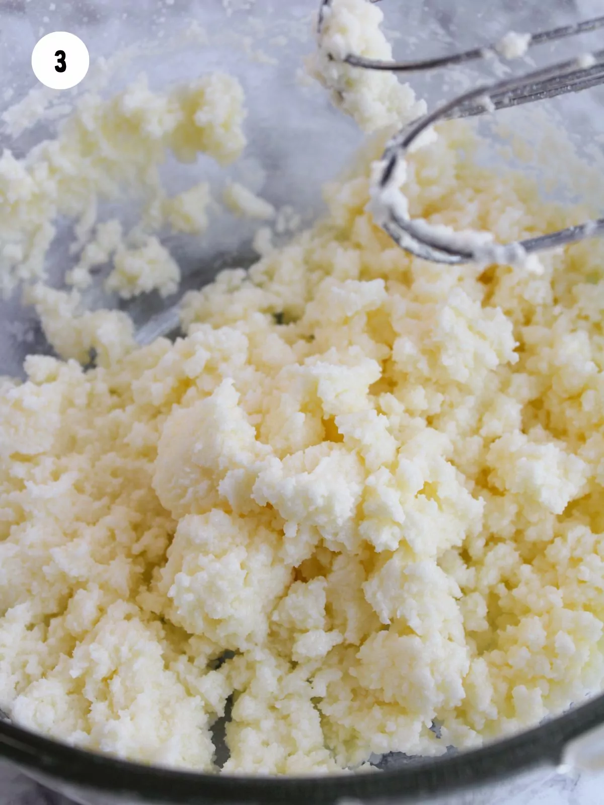 white frosting in mixing bowl