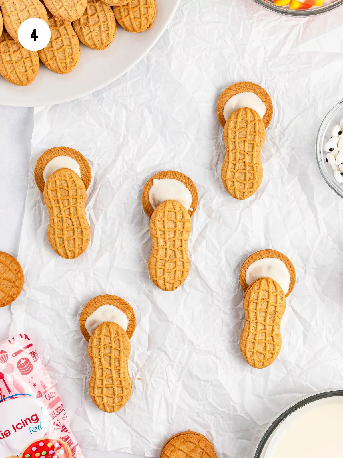 add peanut shaped nutter butter to bottom half of round cookie