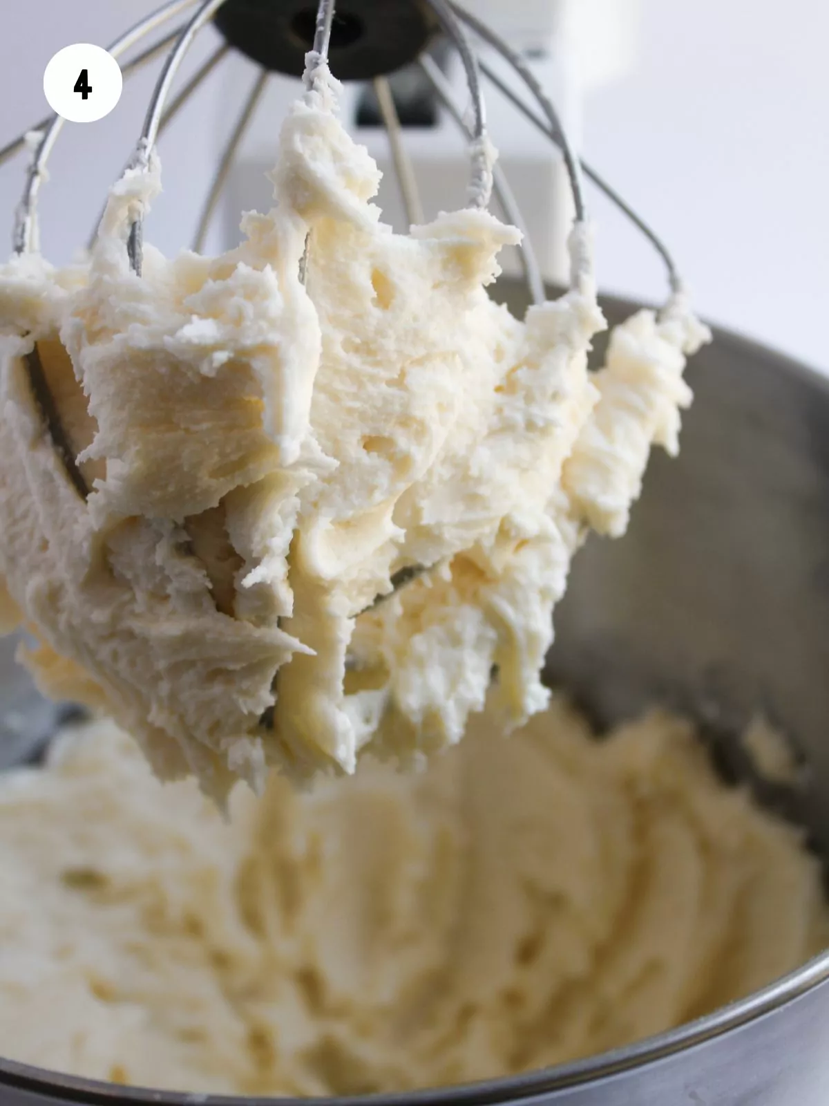 buttercream on a wire whisk attachment to a stand mixer