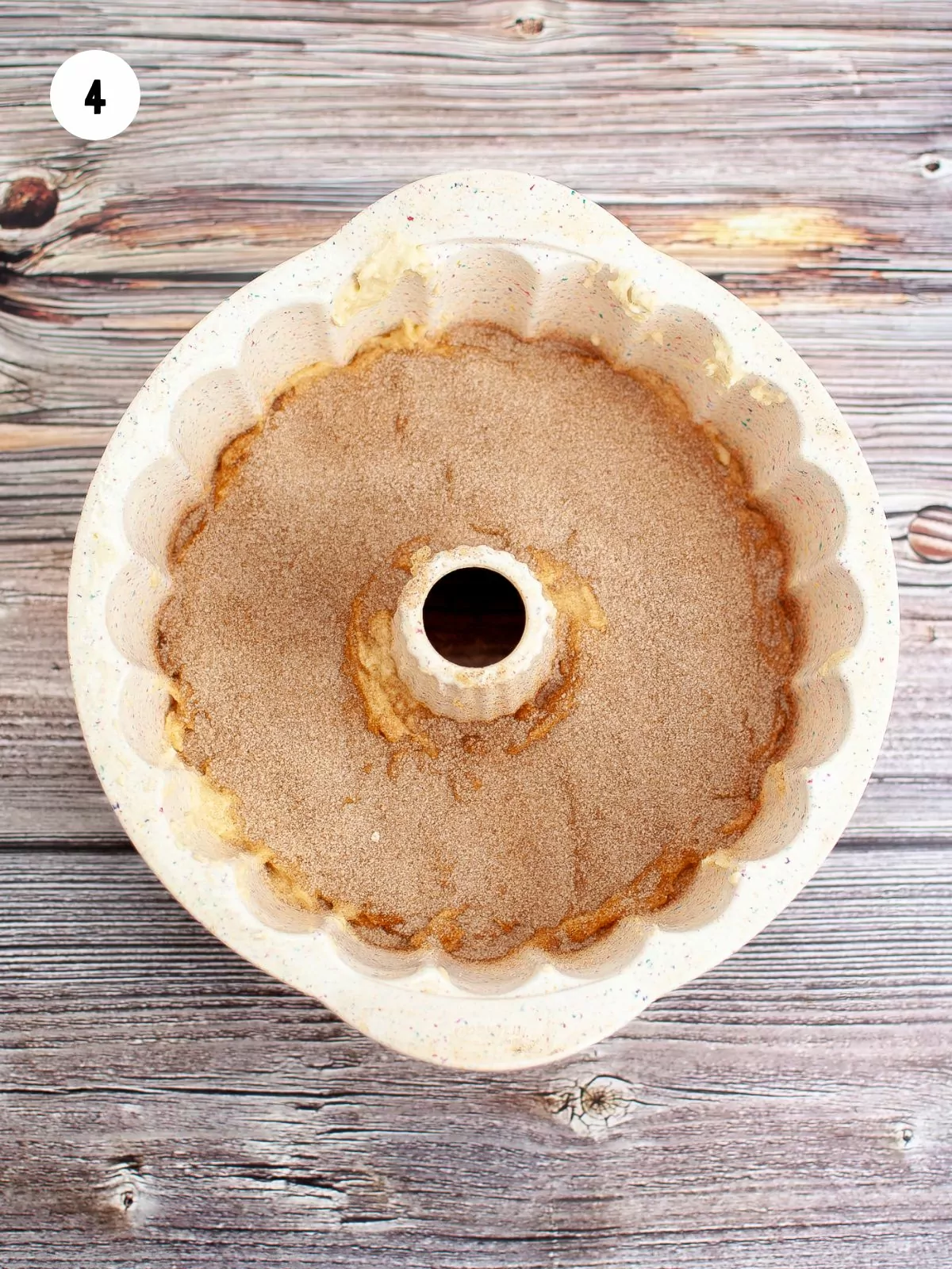 cinnamon sugar sprinkled over the first layer of batter in the bundt pan