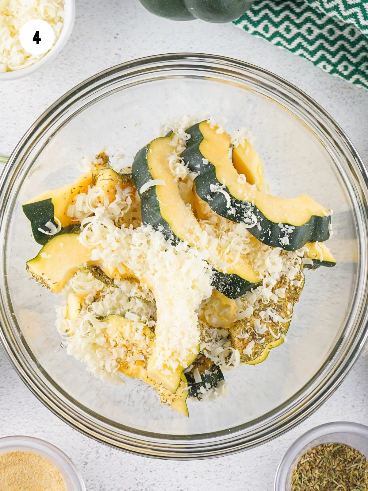 parmesan cheese added to the bowl of acorn squash