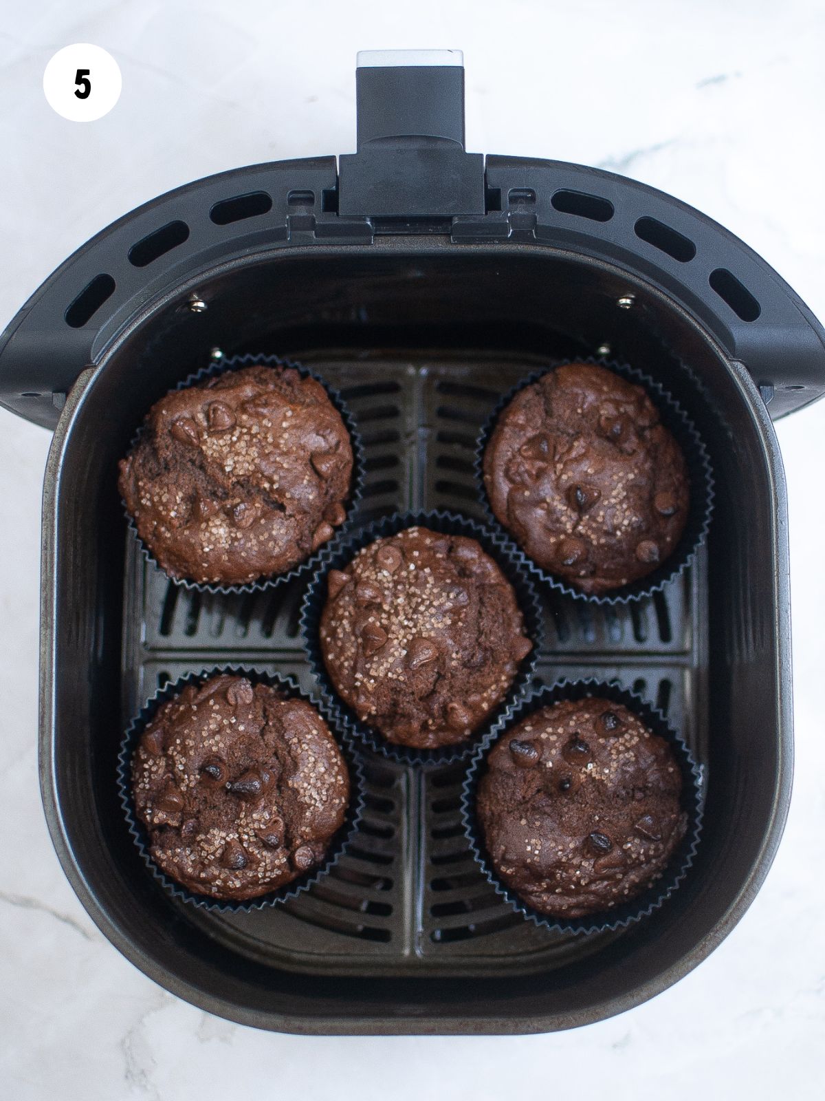 baked chocolate chocolate chip muffins with coarse sugar on top