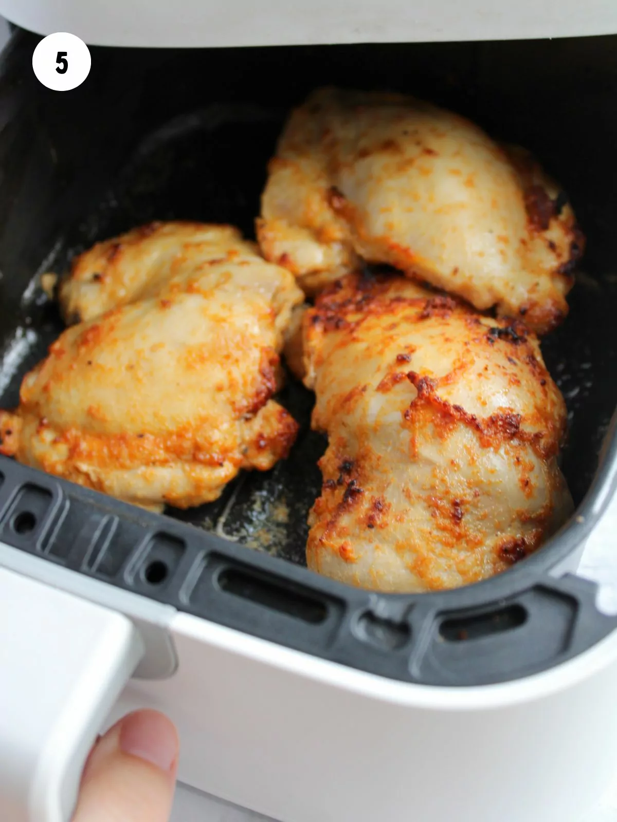 cooked chicken thighs in the air fryer basket