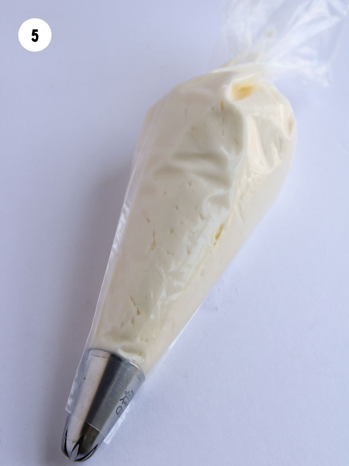 piping bag fitted with a piping tip filled with buttercream