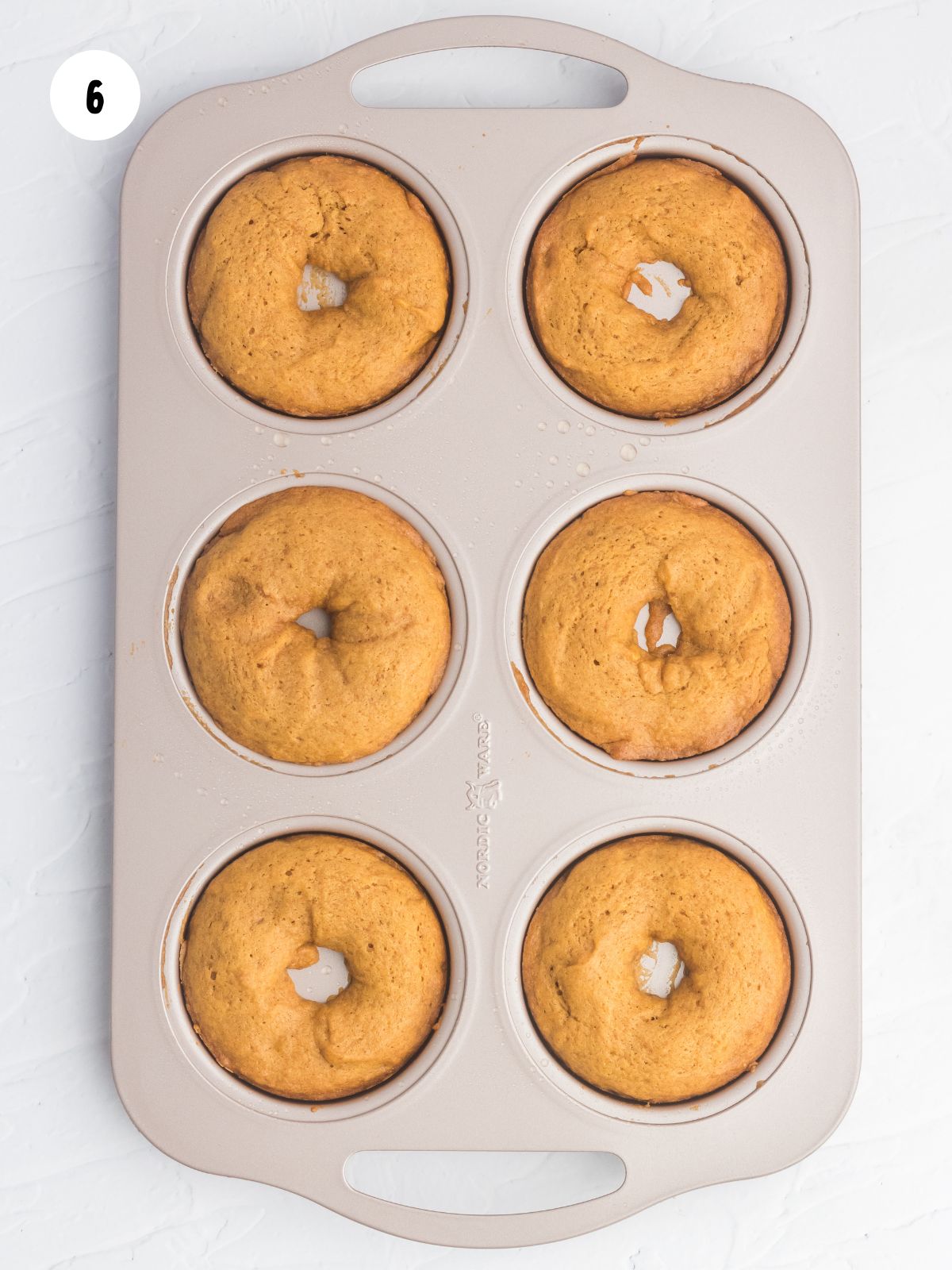 baked pumpkin donuts in a donut pan