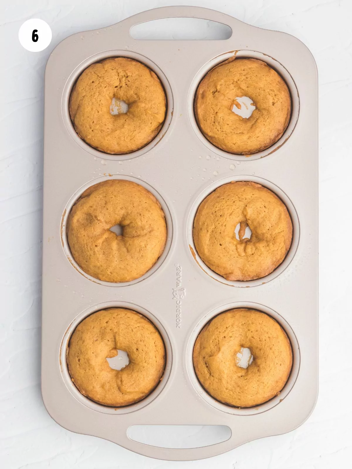 baked pumpkin donuts in a donut pan