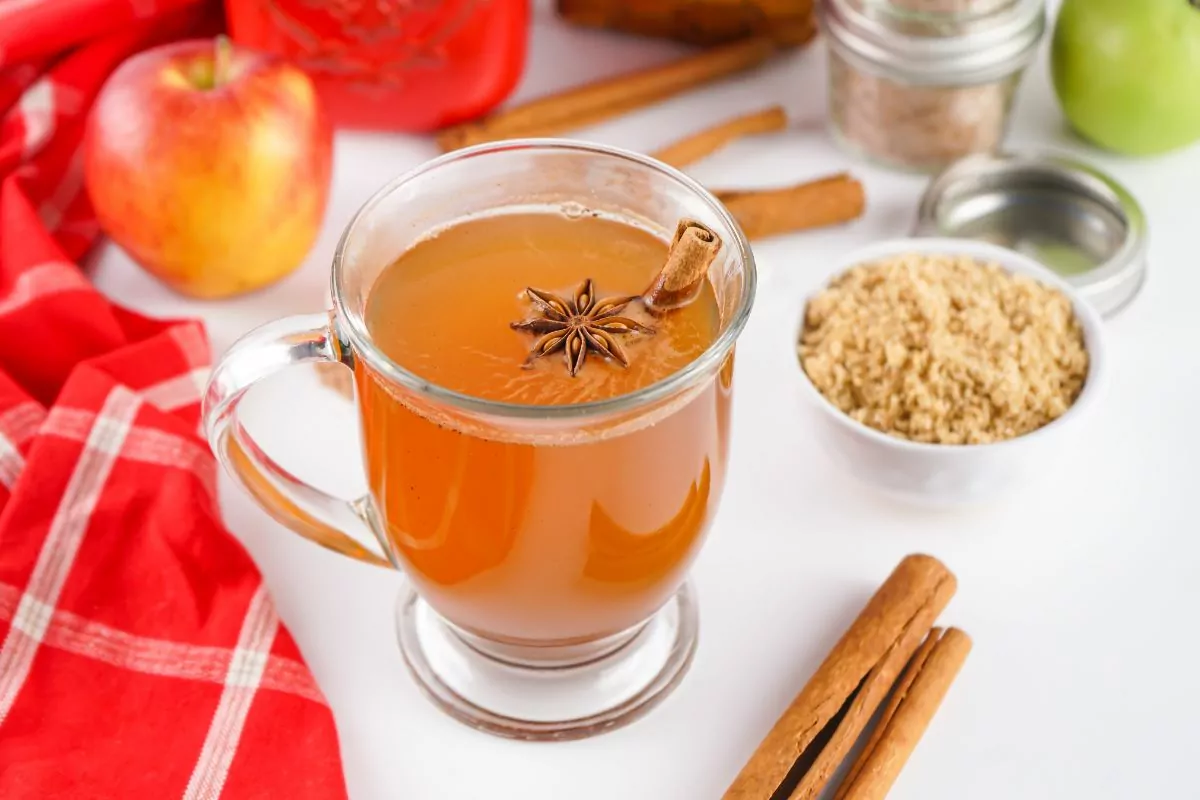 glass mug with drink and drink mix in background.