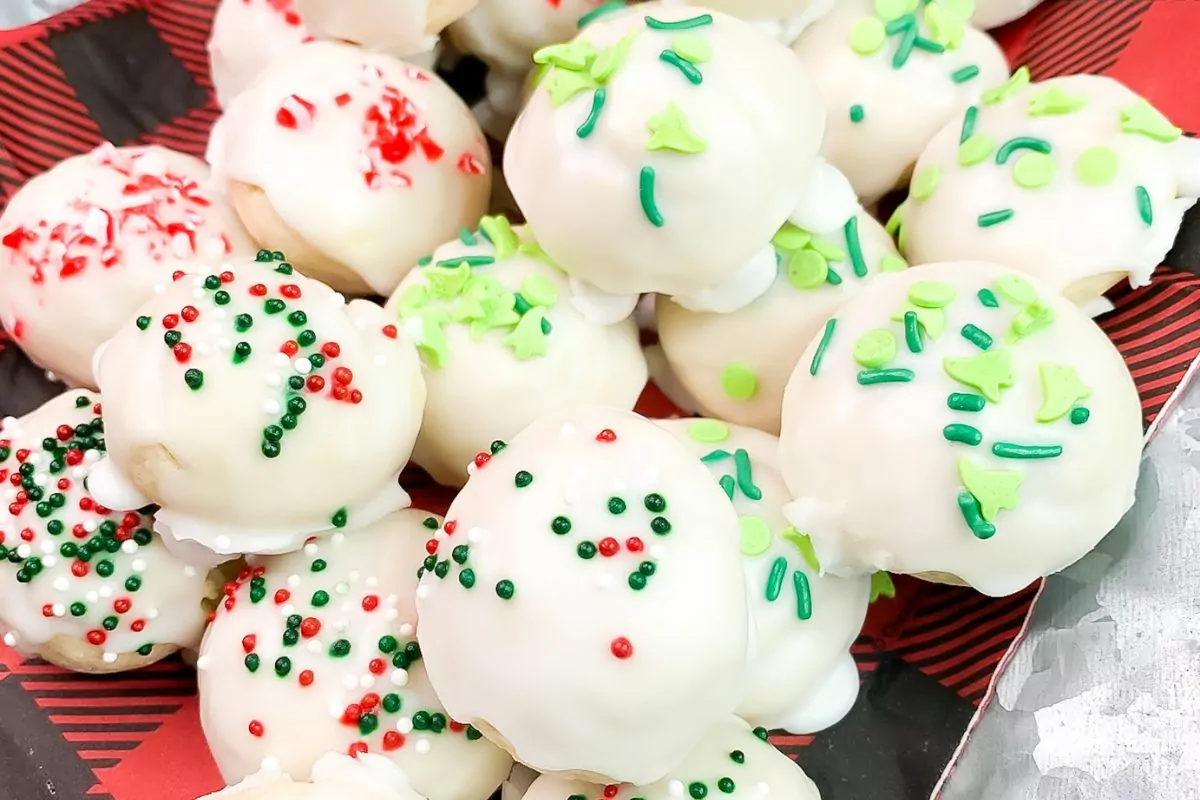 Cookies with white icing and different Christmas sprinkles.