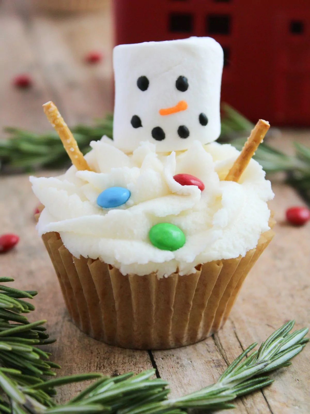 Melting Snowman Cupcake with greenery around the table