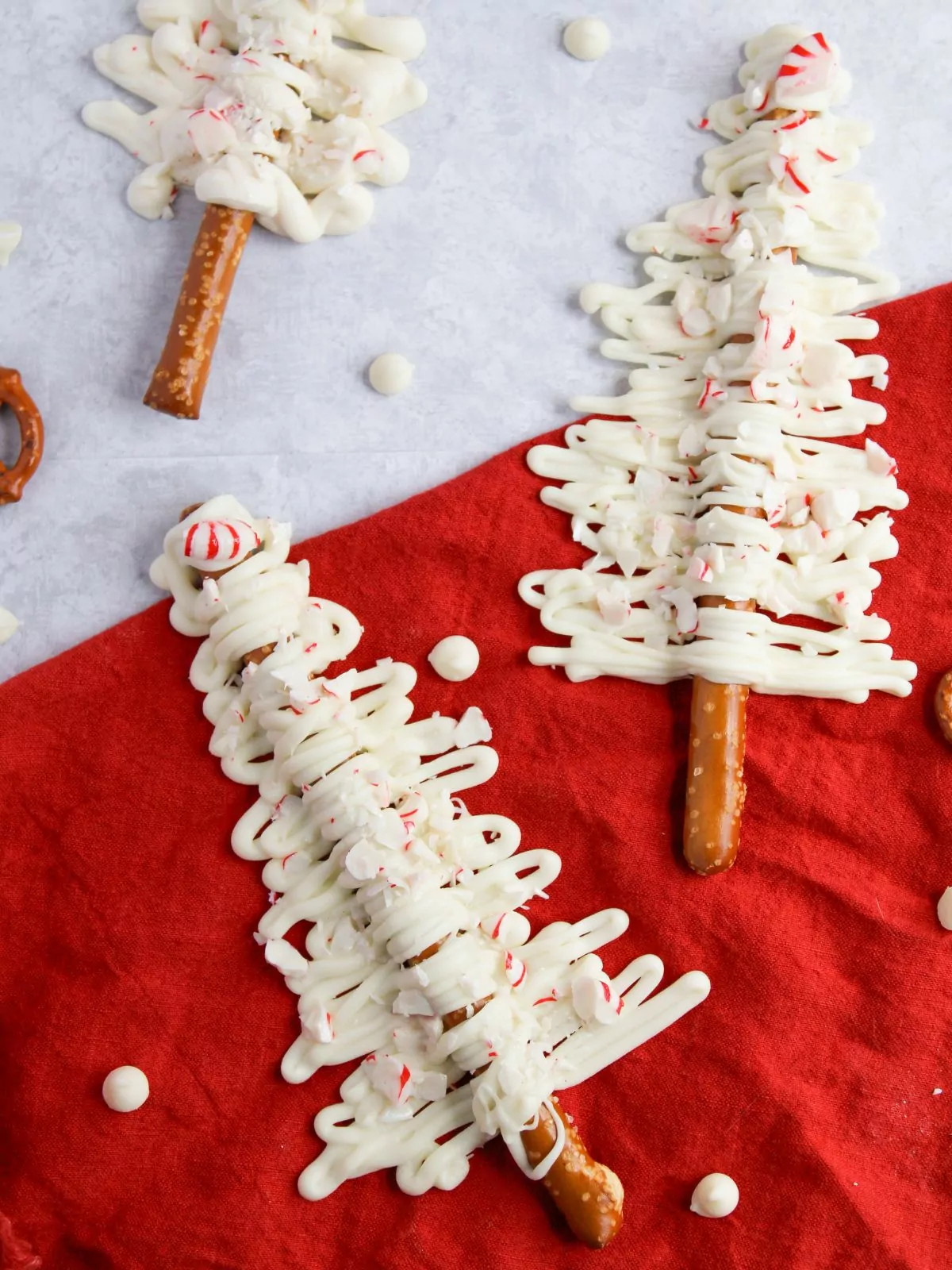 White Chocolate Covered Christmas Tree Pretzels on a red cloth