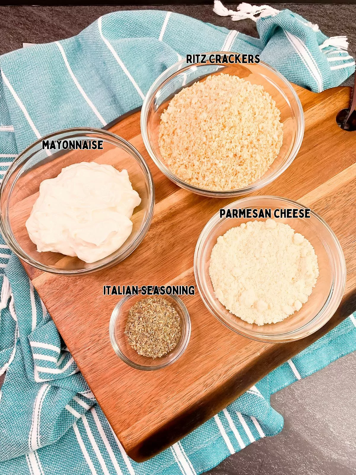 Glass bowls with ingredients for chicken mayonnaise and Ritz crackers.