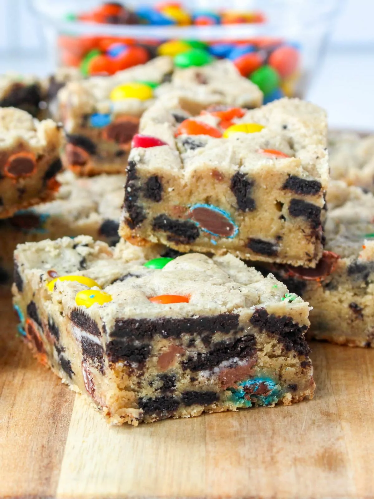 close up of M&M cookie bars filled with Oreos and peanut butter cups